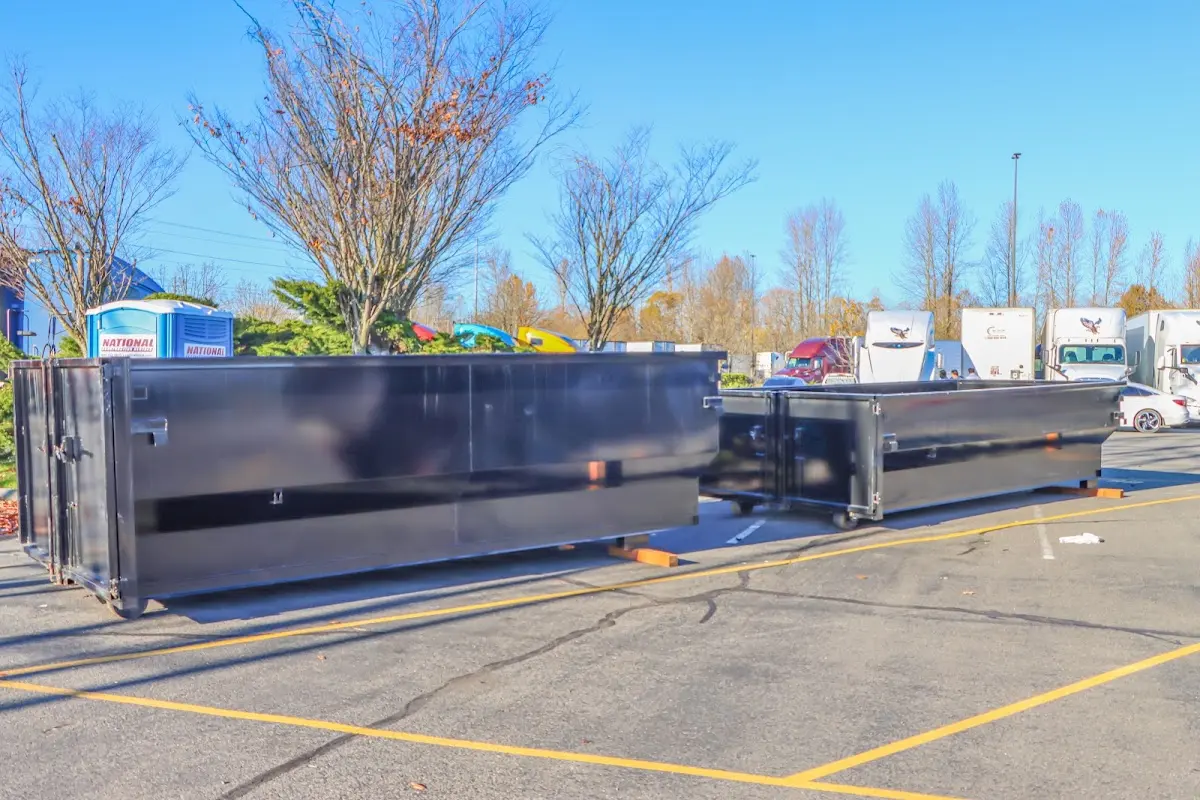 Professional dumpster rental service with roll-off container on residential driveway in Hartford City